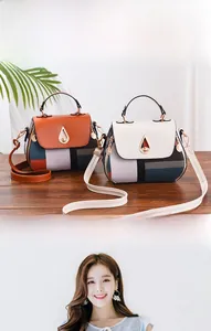 Detail of trendy crossbody shell bags featuring contrast color patchwork and metal teardrop lock