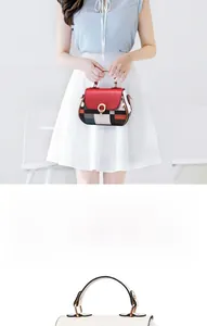 Close-up of contrast color geometric pattern stitching and gold metal buckle on handbag