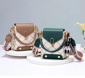 Close-up of diamond quilted mini crossbody bags with gold hardware and woven straps