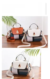 Close-up of geometric color-block shoulder bag with metal teardrop twist lock and zipper