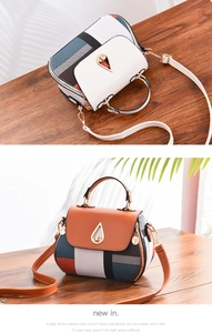 Close-up of dual-tone printed shell bag featuring metallic drop-shaped twist lock detail