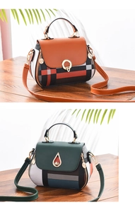Detailed view of fashion plaid shell bags in brown and dark green with metal clasps