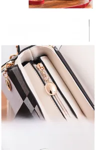 Close-up of golden logo zipper and classic plaid pattern on the shell bag strap