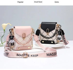Detail of mini quilted crossbody bags with chain, wide strap and cute bear charm