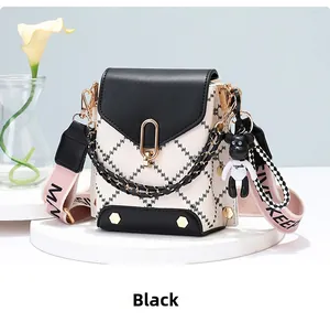 Mini crossbody phone bag with black and white diamond pattern and gold magnetic clasp