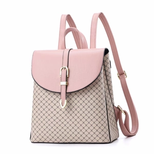 Detail of pink and beige patchwork backpack with diamond pattern and gold hardware