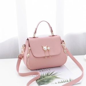 Pink lychee texture shoulder bag with golden cat ear pearl pendant and adjustable strap