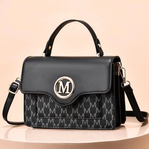 Fashionable black leather and M-print canvas crossbody bag with gold circular logo