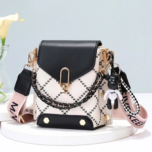 Chic monochrome crossbody phone bag with geometric pattern, chain detail and bear charm