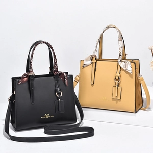 Minimalist large tote bag with silk scarf handle in black and yellow leather finishes