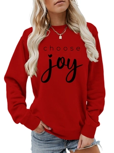 Detail of red crewneck sweatshirt with black choose joy text and heart print