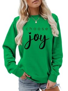 Detail of Choose Joy lettering and heart print on a green crewneck sweatshirt