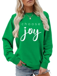 Detail of green crewneck sweatshirt with white choose joy lettering and ribbed cuffs
