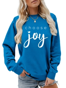 Detail of blue crewneck sweatshirt with white Choose Joy heart font and soft cotton fabric