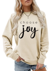 Detail of Choose Joy lettering and ribbed cuffs on beige crewneck sweatshirt