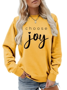 Close-up of ribbed crewneck and Choose Joy lettering on a yellow casual sweatshirt