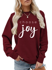 Detail of burgundy sweatshirt with white choose joy text print and ribbed cuffs