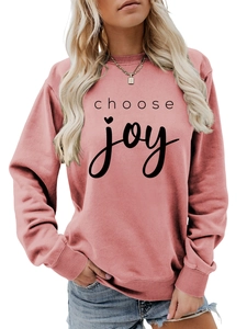 Detail of pink crewneck sweatshirt with choose joy text and heart print