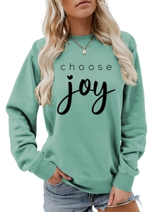 Detail of mint green sweatshirt with choose joy text and heart symbol on chest