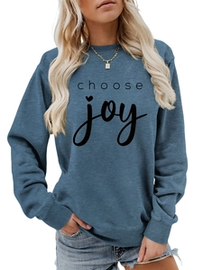 Detail of the ribbed crewneck and choose joy lettering on the blue long sleeve sweatshirt