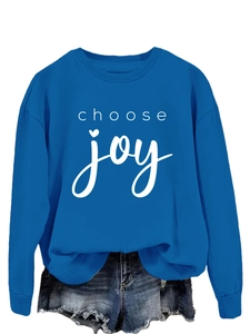 Close-up of royal blue sweatshirt showing choose joy print and ribbed crewneck texture