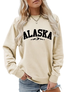 Close-up of beige crewneck sweatshirt with black Alaska mountain print and casual fit