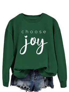 Detail of dark green crewneck sweatshirt featuring white 'choose joy' heart typography