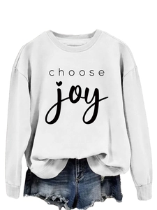 Close-up of black 'choose joy' lettering with a heart on a white crewneck sweatshirt