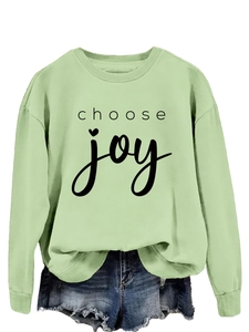 Detail view of mint green crewneck sweatshirt with black Choose Joy text print