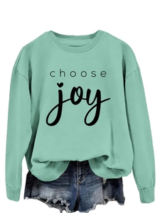 Detail of the crewneck mint green sweatshirt with black choose joy heart print