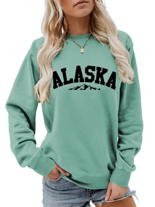 Detail of mint green Alaska sweatshirt featuring black mountain silhouette print