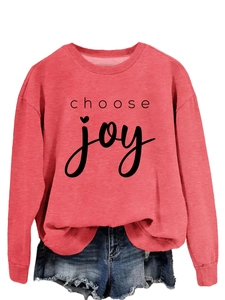 Flat lay detail of coral pink choose joy sweatshirt and distressed denim shorts