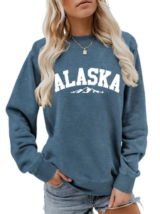 Close-up of Alaska mountain graphic and ribbed crewneck on blue long sleeve sweatshirt