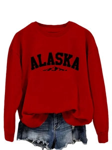 Detail of red Alaska graphic sweatshirt paired with distressed blue denim shorts