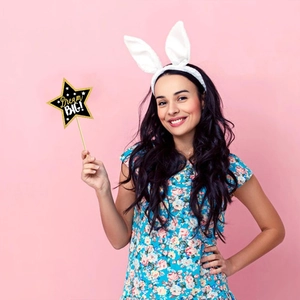 Close-up of plush white bunny ears headband and Dream BIG star wand for graduation photos