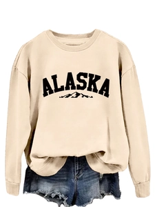 Close-up of beige ALASKA mountain print sweatshirt with soft knit fabric detail