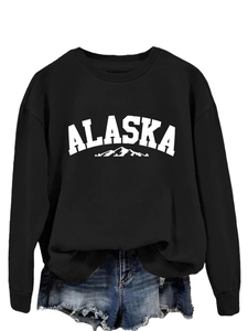 Detail of Alaska graphic print on a casual black crewneck sweatshirt with denim shorts