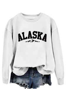 Detailed shot of white round neck sweatshirt with black Alaska print and mountain graphic