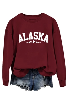 Close-up of rib-knit neckline and white Alaska mountain print on burgundy sweatshirt