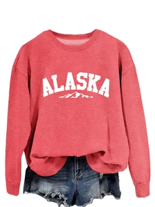 Detail of red crewneck sweatshirt featuring white ALASKA text and mountain silhouette print