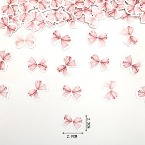 Dettaglio coriandoli a fiocco rosa acquerello con dimensioni 2,9cm di larghezza e 2,2