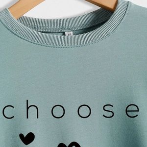 Minimalist sage green crewneck sweatshirt featuring black 'choose' lettering and heart
