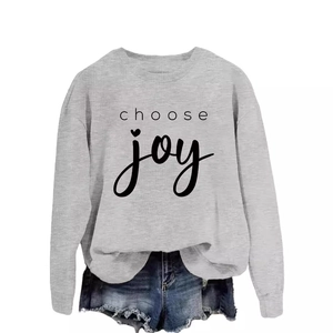 Light grey crewneck sweatshirt featuring black Choose Joy lettering and raw hem denim shorts
