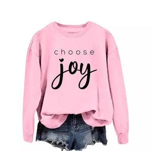 Pink crewneck sweatshirt with 'choose joy' heart print paired with denim shorts