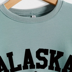 Relaxed fit round neck Alaska sweatshirt for women in sage green with black lettering