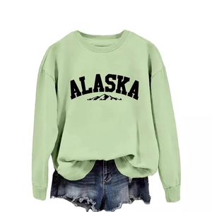 Mint green Alaska sweatshirt with round neck and denim shorts on white background
