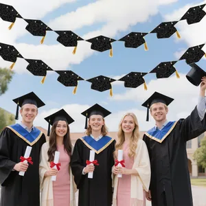 Detail of graduation banner with black glitter mortarboard caps and gold tassels