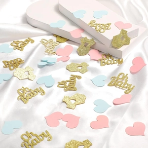 Pastel pink, blue, and gold glitter Oh Baby confetti with heart and onesie shapes on silk