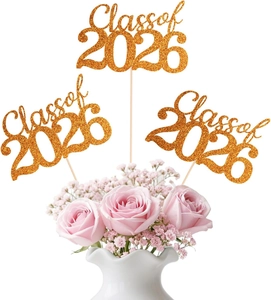 Glittery gold Class of 2026 cake toppers placed in a pink flower bouquet for graduation