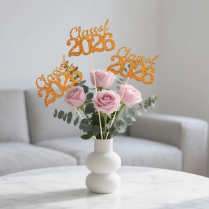 Gold glitter Class of 2026 cake toppers in a floral bouquet for graduation party